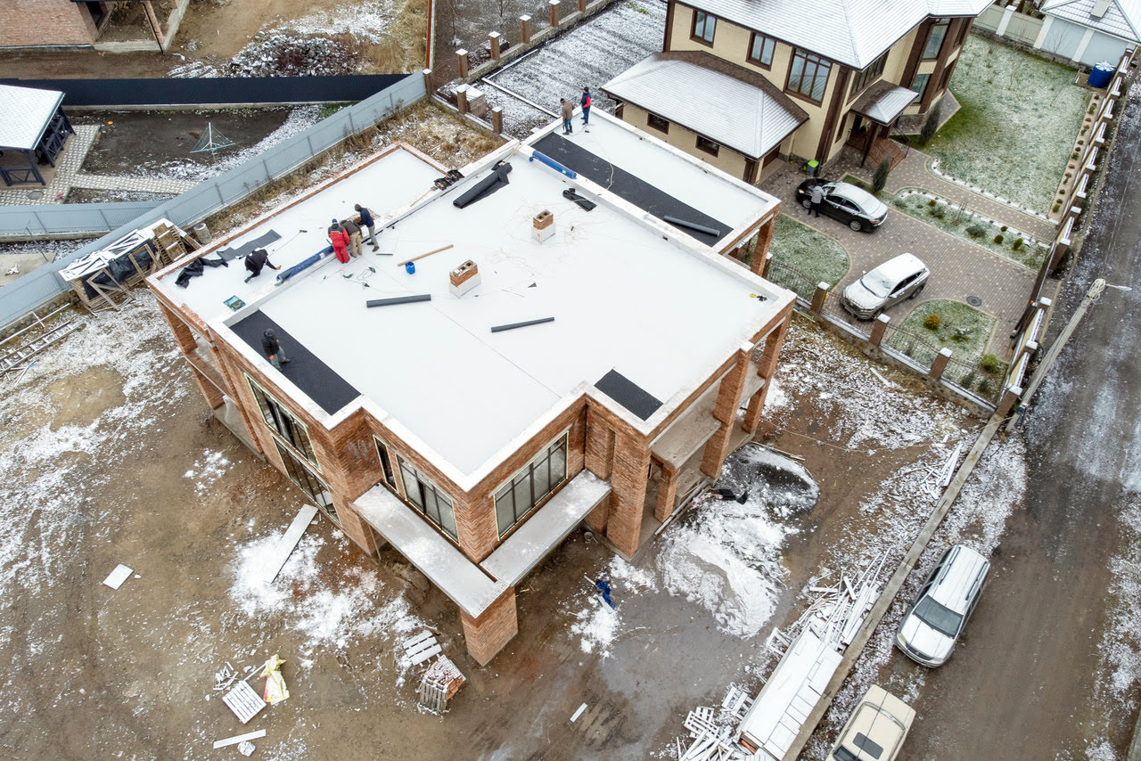Are Flat Roofs Bad? | Commercial and Industrial Flat Roof Work Site in Winter | getflatroofing.com