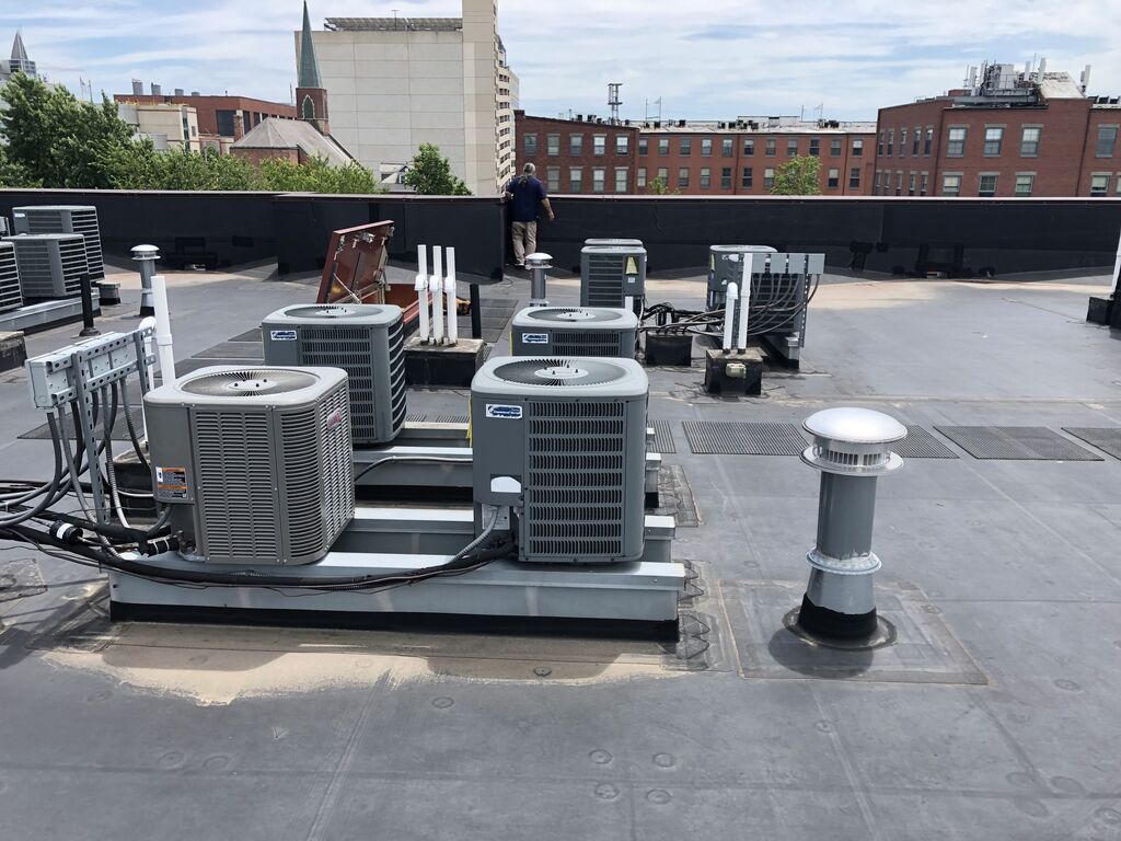 Air Conditioning Equipment on Raised Platforms on Commercial Flat Roof | getflatroofing.com 