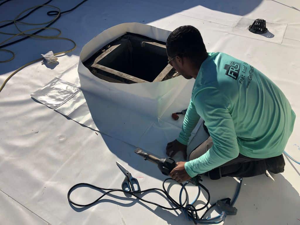 A Flat Roof Solutions roofer installing a Duro-Last single-ply roof membrane | getflatroofing.com 
