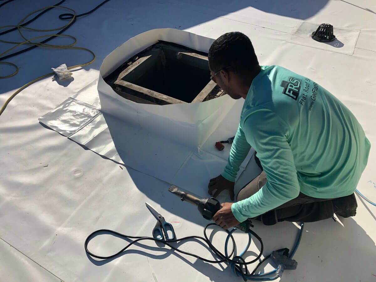 Flat Roof Solutions Employee Working on Flat Roof | getflatroofing.com 