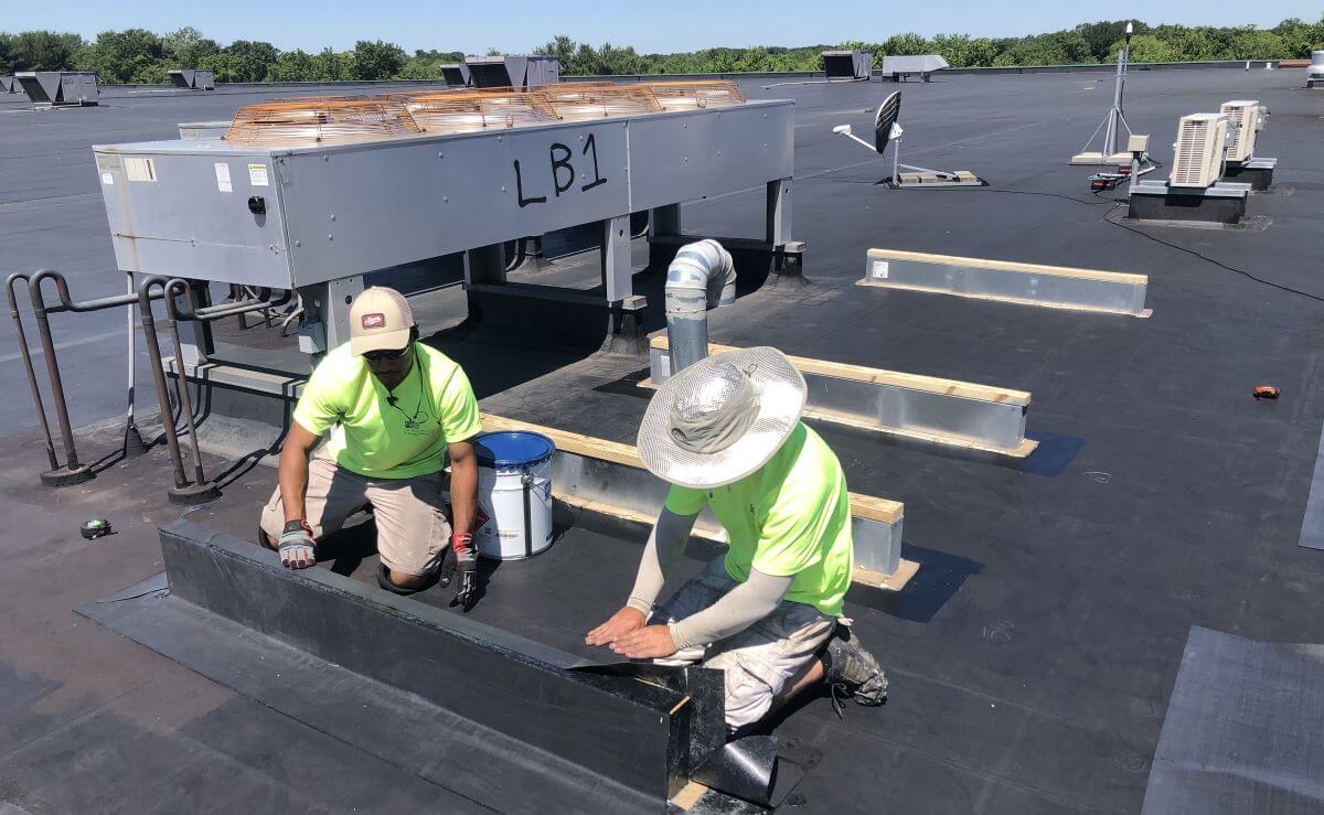 Flashings being inspected on commercial flat roof | Flat Roof Solutions